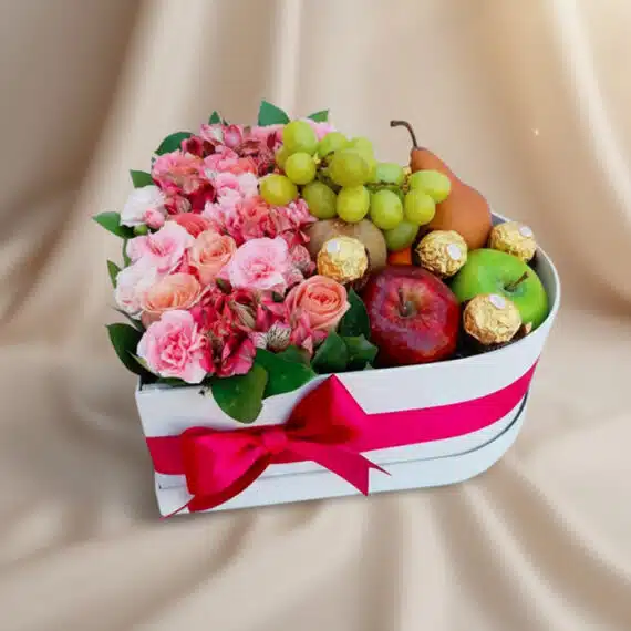 Arreglo AMOS: Caja Corazón de Rosas, Frutas y Ferrero para Regalo Arreglo AMOS en caja corazón con rosas rosadas, alstroemerias, uvas, manzanas, pera y chocolates Ferrero Rocher, ideal para r